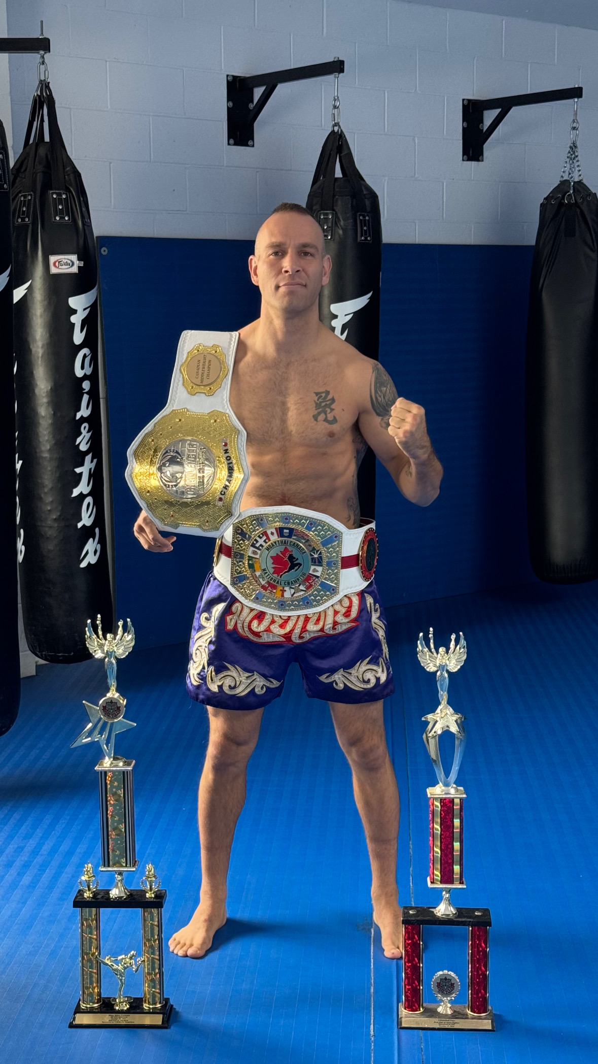 Dustin Little — dual championship belts and trophies